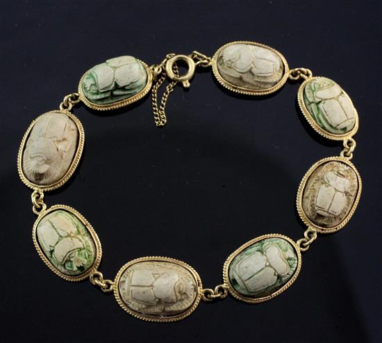 An 18ct gold and Egyptian faience scarab bracelet, 7in.